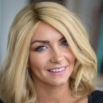 Smiling Alopecia Areata Client with her blonde mid length Enhancer system