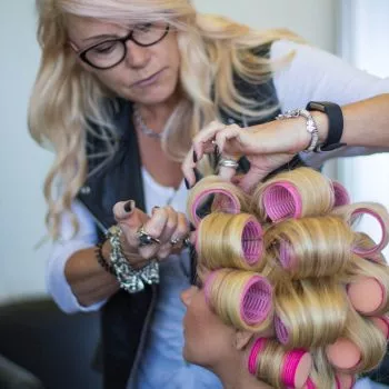 Female Stylist putting rollers in Alopecia Areata client's Enhancer System