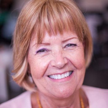 Smiling mature lady after fitting of short bob hair enhancement system