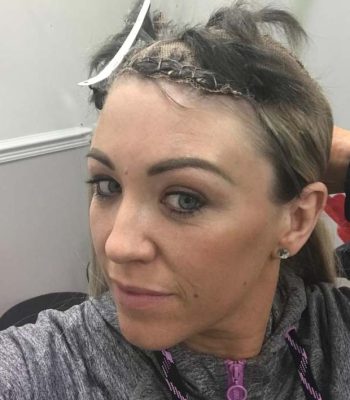 Extensions being added to female clients hair system
