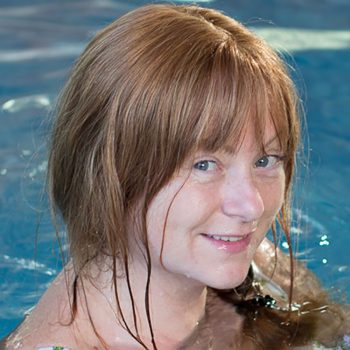 Smiling Client With Trichotillomania wears Enhancer System while swimming and no longer worries about getting hair wet