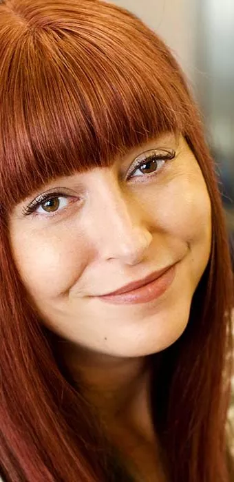 Smiling female with red Enhancer System and fringe
