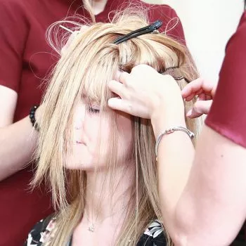 Close up on blonde female with Trichotillomania having wefts attached