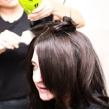 Female client with brown hair having blow dry