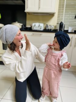 Victoria in a hat and her little girl wearing a turban