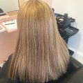 Female client with long straight hair after the fitting of her Enhancer System
