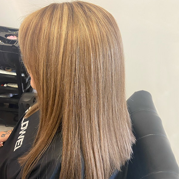 Female client with long straight hair after the fitting of her Enhancer System